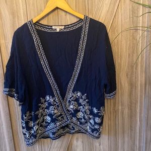 Navy blue with white floral embroidery.